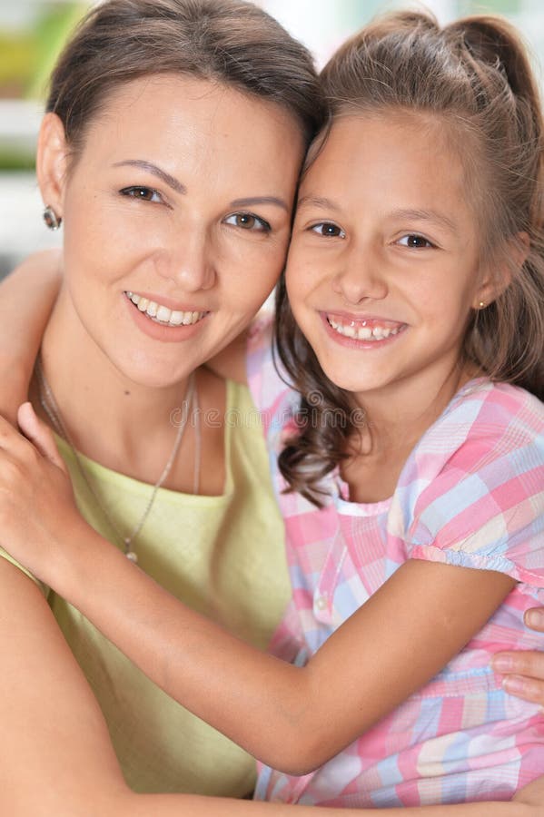 Portrait of a beautiful woman and girl hugging stock photo Portrait of a beautiful woman and girl hugging stock photo
