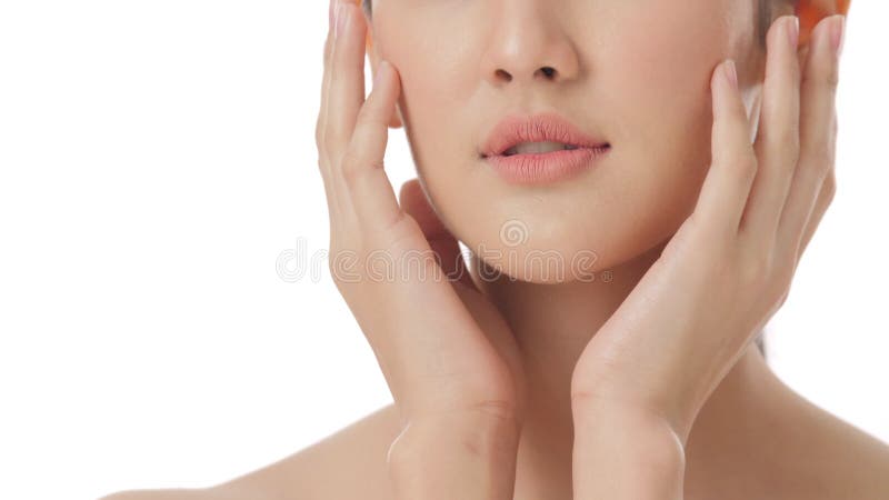 Close up portrait of beautiful young asian woman touching face and healthy skin in slow motion skincare concept.