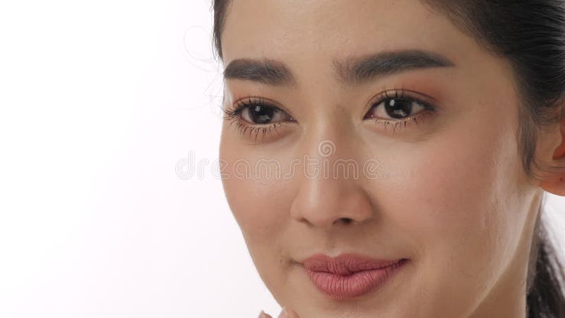 Close up portrait of beautiful young asian woman touching face and healthy skin in slow motion skincare concept.