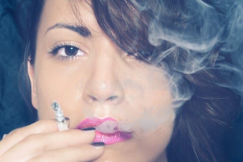 Close up portrait of beautiful young girl smoking cigarette with a lot of smoke royalty free stock photo Close up portrait of beautiful young girl smoking cigarette with a lot of smoke royalty free stock photo