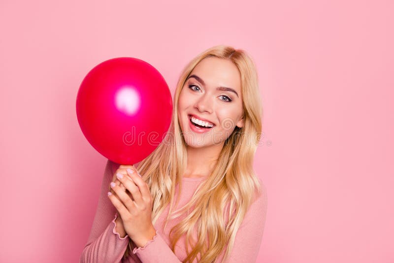 Close up portrait of beauty, cute girl with red air balloons laughing over pink background, beautiful Happy Young woman on birthda