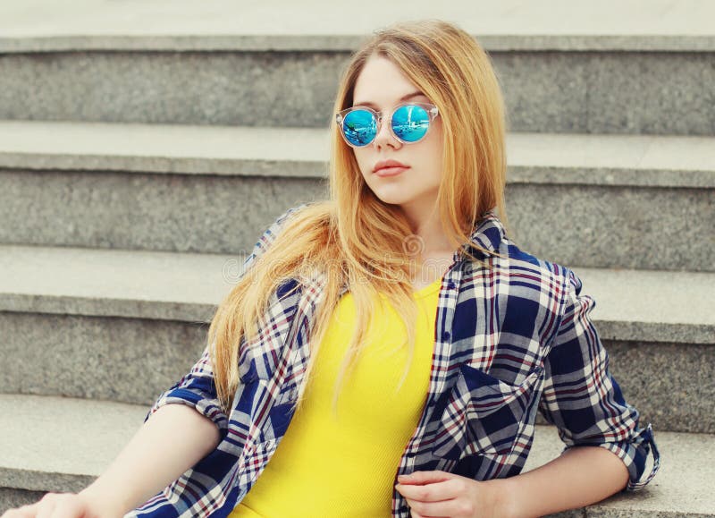 Portrait Of Blonde Teenager Girl Wearing Sunglasses Looking At Camera