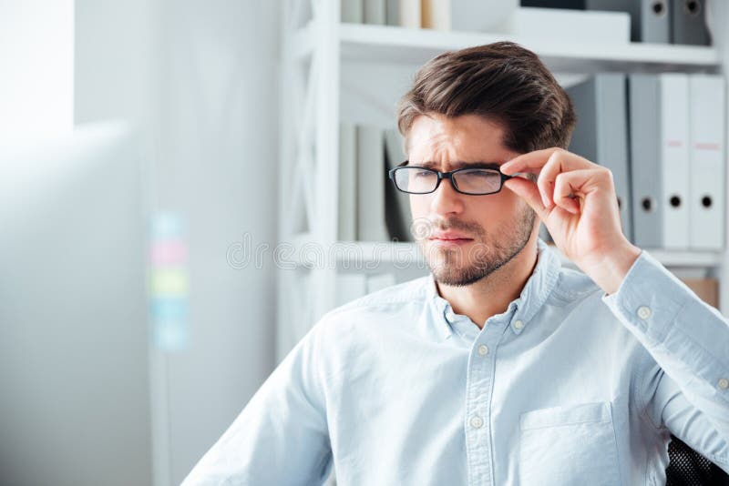 Close-up portrait of businessman in eyeglasses looking at monitor stock photography Close-up portrait of businessman in eyeglasses looking at monitor stock photography