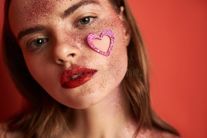 Young brunette girl with creative make up and heart-shaped sticker on face stock images Young brunette girl with creative make up and heart-shaped sticker on face stock images