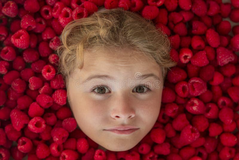 Close-up portrait of child isolated over raspberry violet purple background. stock photography