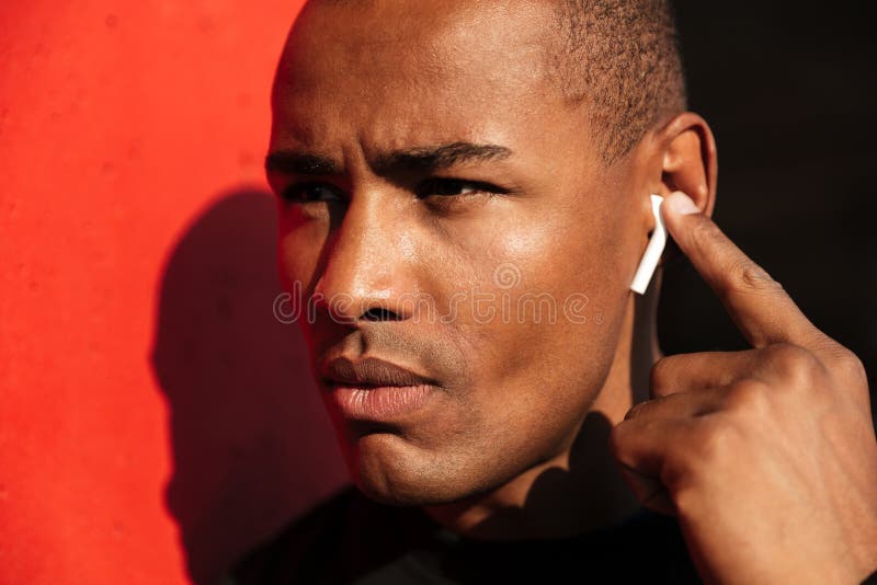 Close up portrait of a concentrated young african man stock photo Close up portrait of a concentrated young african man stock photo