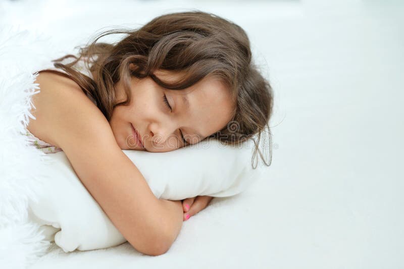 Close up portrait of cute little girl sleeping in bed. Close up portrait of cute beautiful little girl sleeping in bed at home stock photo Close up portrait of cute little girl sleeping in bed. Close up portrait of cute beautiful little girl sleeping in bed at home stock photo