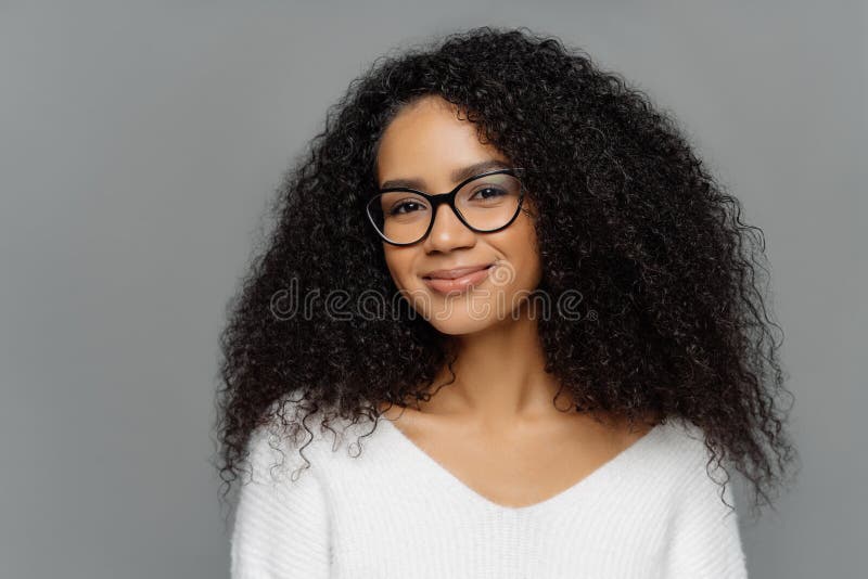 Headshot of Curly Haired Smiling Woman Has Healthy Dark Skin, Afro Hairstyle, Smiles Gently at Camera, Weras Optical Glasses and Stock Photo - Image of female, healthy: 154522420 Headshot of Curly Haired Smiling Woman Has Healthy Dark Skin, Afro Hairstyle, Smiles Gently at Camera, Weras Optical Glasses and Stock Photo - Image of female, healthy: 154522420