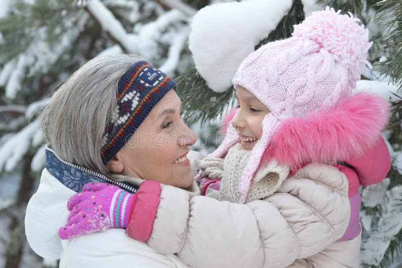 Portrait of grandmother and granddaughter in winter. Close up portrait of grandmother and granddaughter in winter royalty free stock photo Portrait of grandmother and granddaughter in winter. Close up portrait of grandmother and granddaughter in winter royalty free stock photo