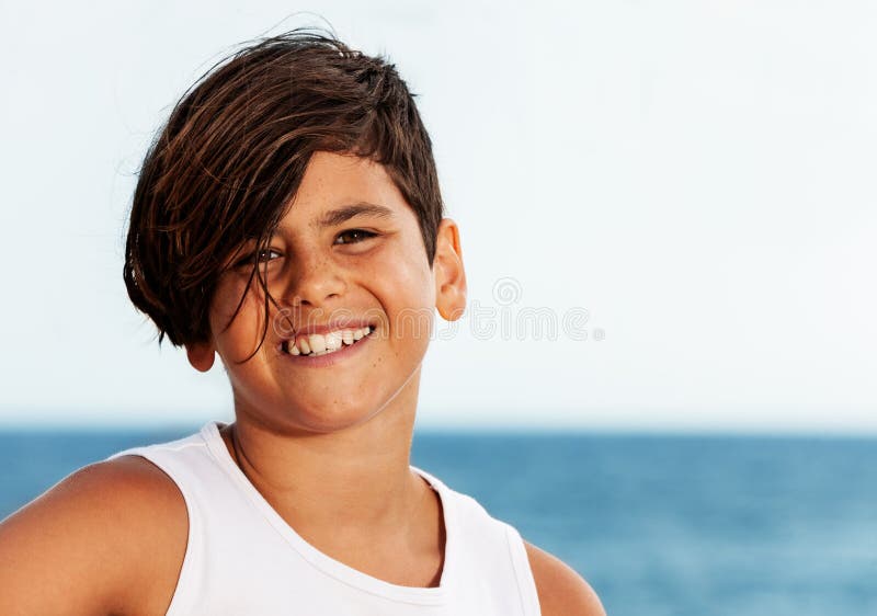 Handsome teenage Hispanic boy against seascape stock photos Handsome teenage Hispanic boy against seascape stock photos