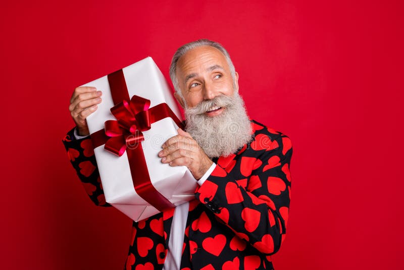 Close-up portrait of his he nice attractive cheerful cheery white-haired guy cherub holding in hand gift congrats