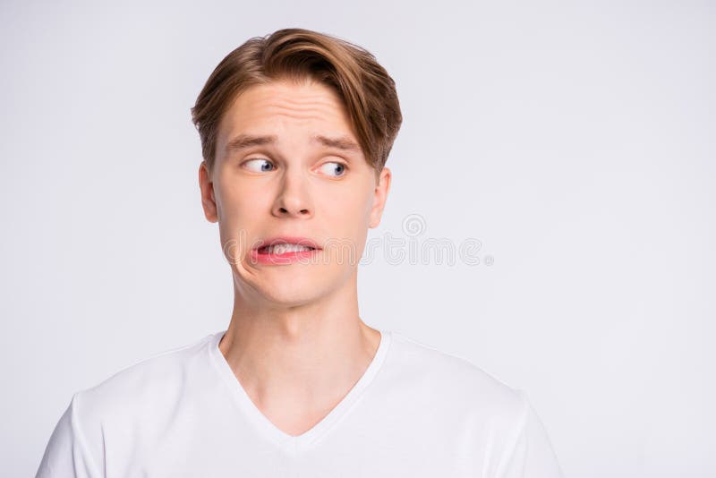 Close-up portrait of his he nice cute attractive worried uncertain guy looking aside oops mistake fail isolated over stock image Close-up portrait of his he nice cute attractive worried uncertain guy looking aside oops mistake fail isolated over stock image