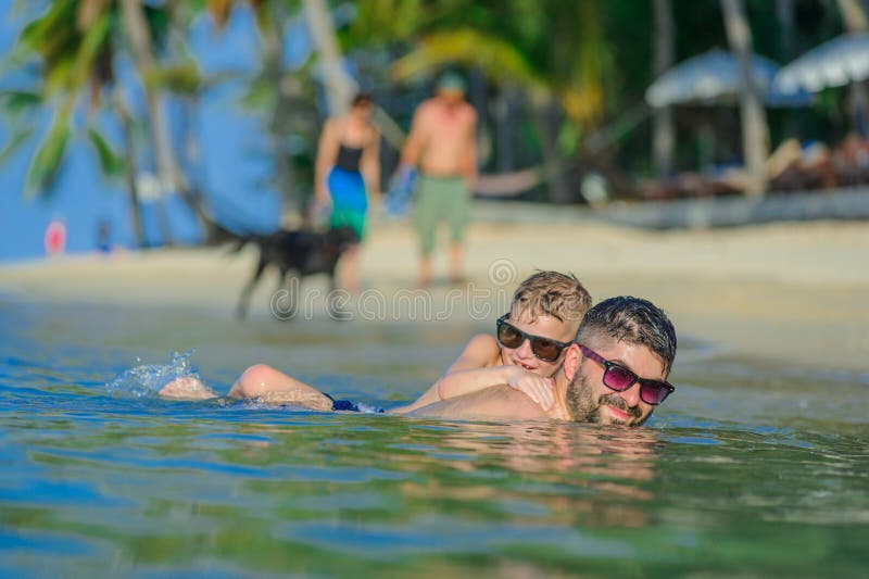 Close-up portrait of a men and his son in water: seven years old royalty free stock image Close-up portrait of a men and his son in water: seven years old royalty free stock image