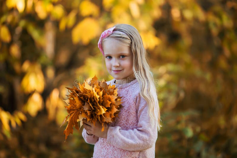 Close-up Portrait of Pretty Little Girl Resting in Autumnal Park Stock ...