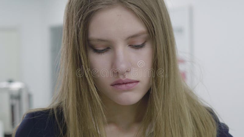 Portrait Of Sad Tired Young Lady In Formal Clothes Who Grabs Her Hair And Looks Away And Down 