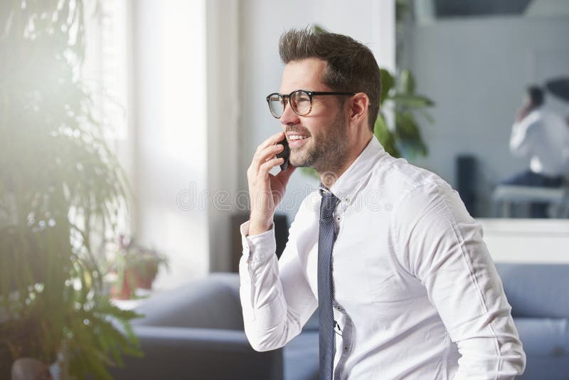 Businessman making a call while sitting in the office royalty free stock photo Businessman making a call while sitting in the office royalty free stock photo