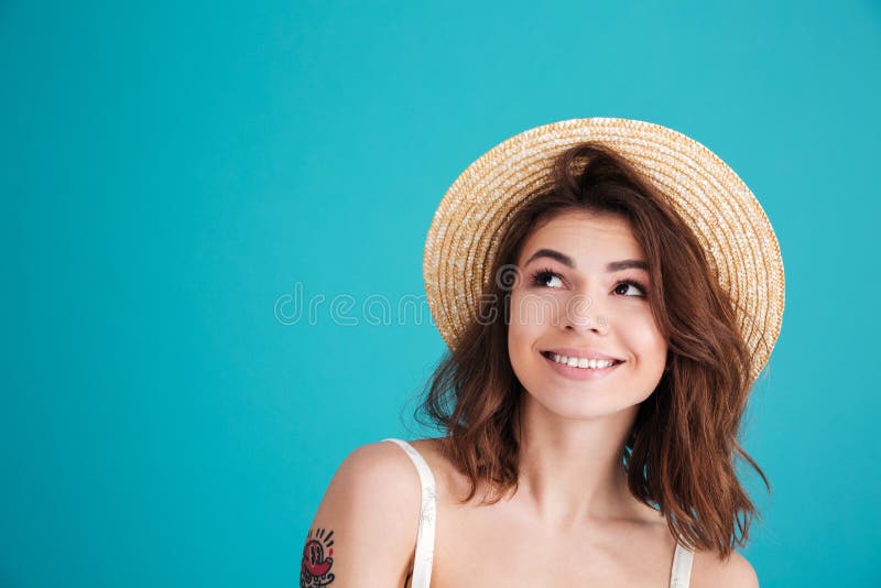 Close up portrait of a smiley young girl in straw hat