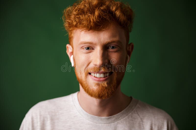 Close Up Portrait Of Smiling Curly Redhead Man Listening To Mus