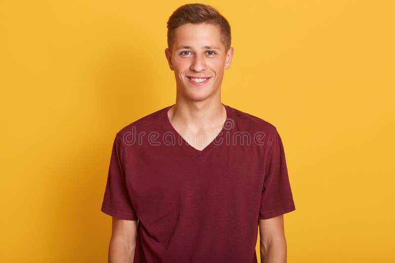 Close up portrait of smiling handsome man with blond hair, wearing in burgunde casual t shirt, standing and looking at camera, royalty free stock images Close up portrait of smiling handsome man with blond hair, wearing in burgunde casual t shirt, standing and looking at camera, royalty free stock images