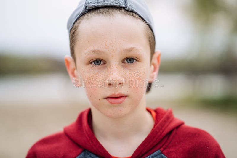 Close-up portrait of teenage boy with freckles on his face