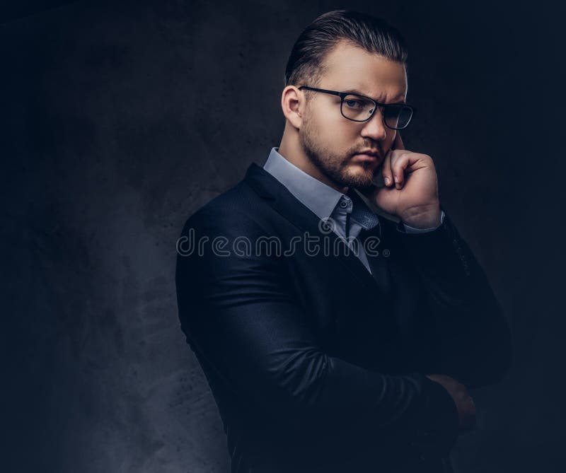 Portrait Of A Stylish Male In A Black Suit And Red Tie Isolated On