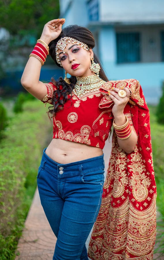 Close up Portrait of very beautiful sexy indian bride in red lehenga showing navel. Non Bengali bridal portrait