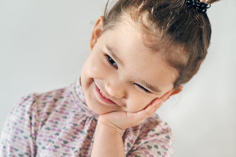 Close-up portrait on a white background happy joyful little girl royalty free stock images Close-up portrait on a white background happy joyful little girl royalty free stock images