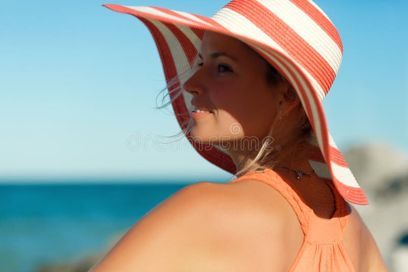 Close up portrait of Woman in orange dress on sea beach
