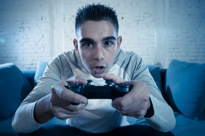 Gamer using controller to play online video games on computer. Man playing  game with joystick and headphones in front of monitor. Player having gaming  equipment, doing fun activity Stock Photo - Alamy