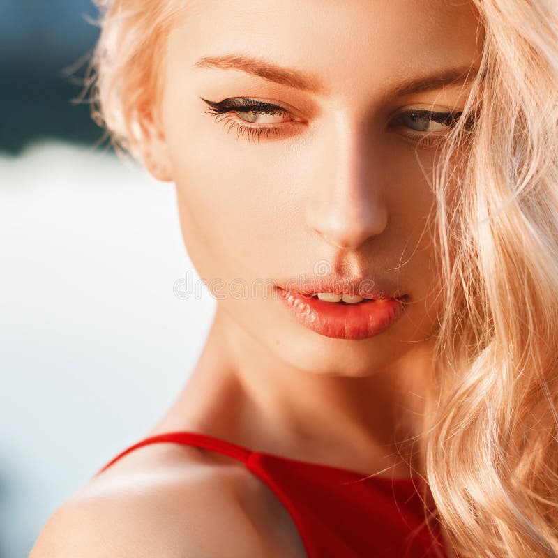 Close-up portrait of young beautiful woman, on blue background s