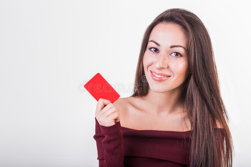 Close-up portrait of young smiling business woman holding credit card