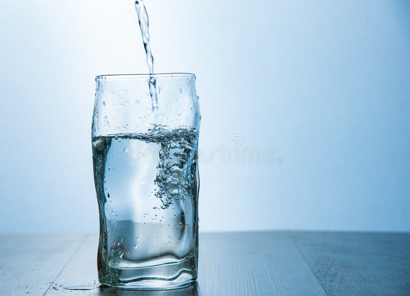 Close Up The Pouring Purified Fresh Drink Water From The Bottle On