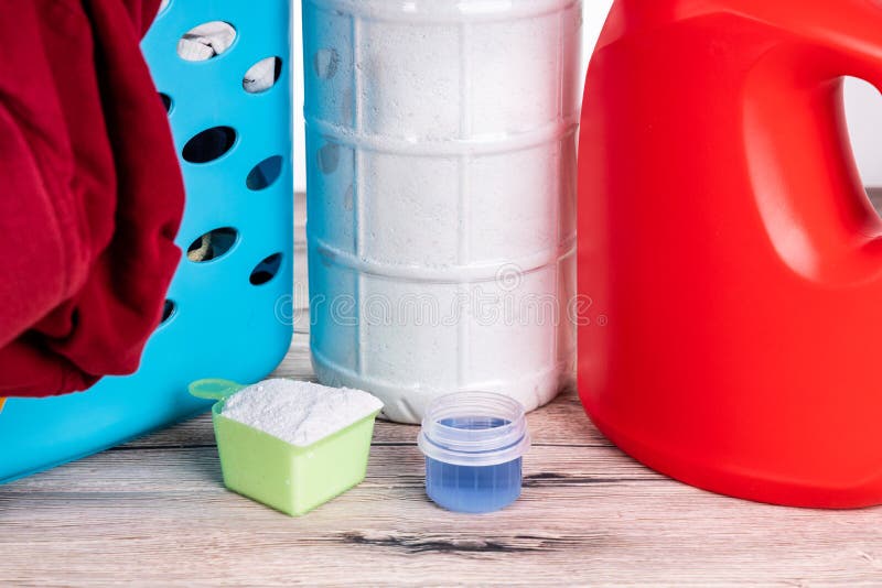 Closeup on Powder and Regular Liquid Laundry Detergent on Wooden