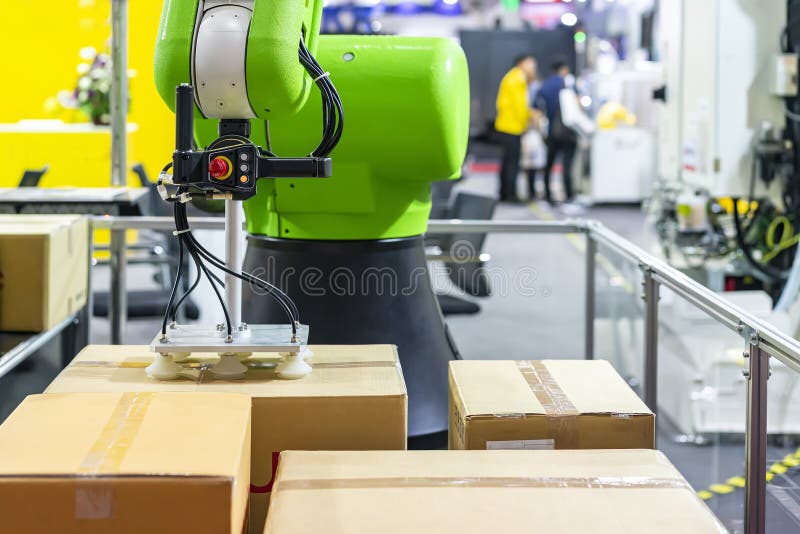 Close up precision robot arm and automatic vacuum or suction cup for pick - place transport paper box or various material sheet plate goods product of manufacturing process in industrial.