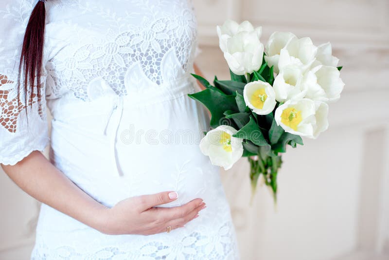 Close-up pregnant woman in white room. stock images Close-up pregnant woman in white room. stock images
