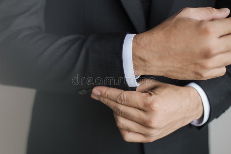 Close Up Preparation Pose of a Man Fixing and a Man Holding Buttons on ...