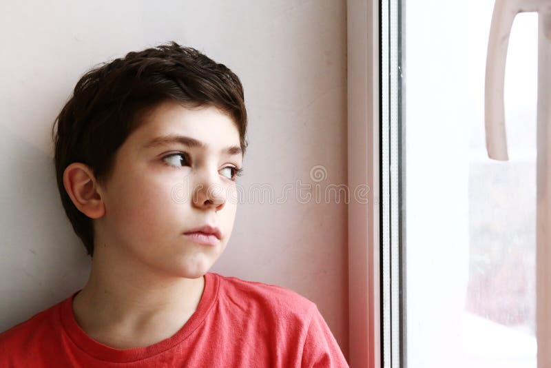 Close up preteen boy portrait look at the window