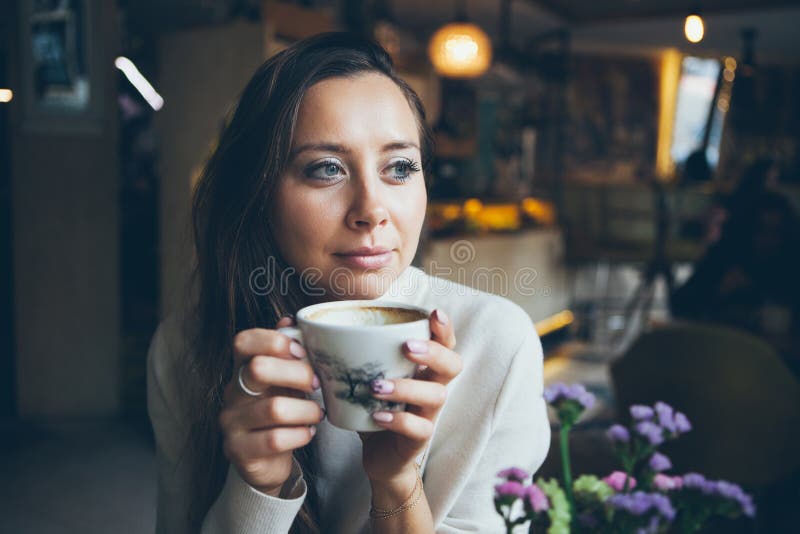 Close-up of pretty woman drinking cup of coffee in autumn / winter evening day. stock photography Close-up of pretty woman drinking cup of coffee in autumn / winter evening day. stock photography