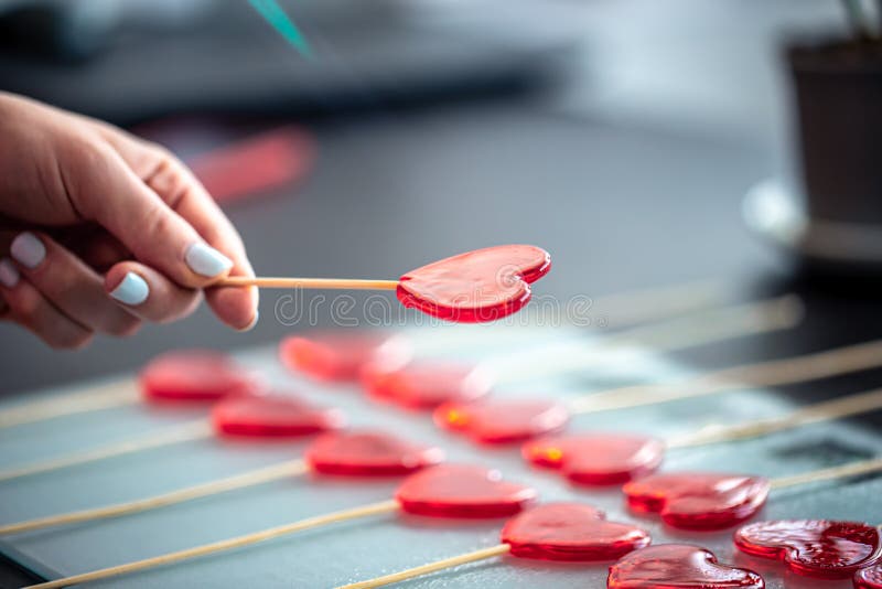 Close-up, the process of making heart-shaped lollipops.