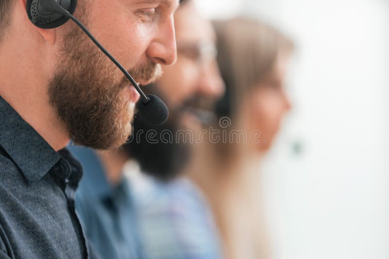 Close up. professional call center employee in the workplace.