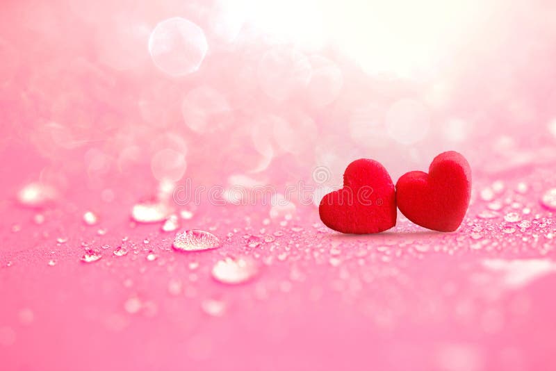 Close up The red Heart shapes with rain water drops on pink sponge surface as love romance abstract background