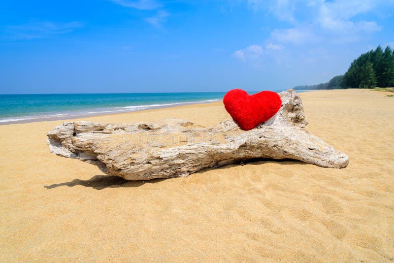 Close up red hearts on ocean beach sand