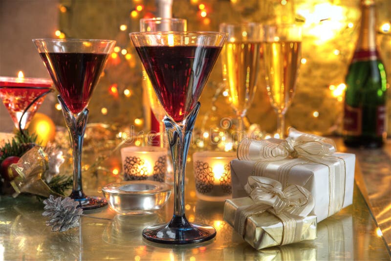 Close-up of red wine in glasses,candle and gifts