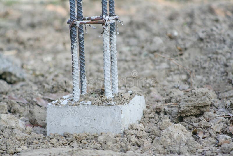 Reinforced concrete and steel structure of pole for make concrete fence construction on the ground stock photo Reinforced concrete and steel structure of pole for make concrete fence construction on the ground stock photo