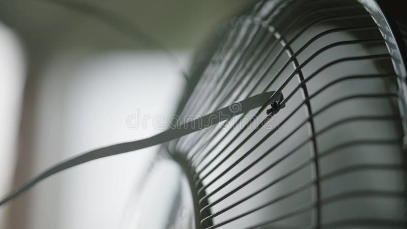 Close-up of a ribbon tied to a modern fan and dangling in the wind