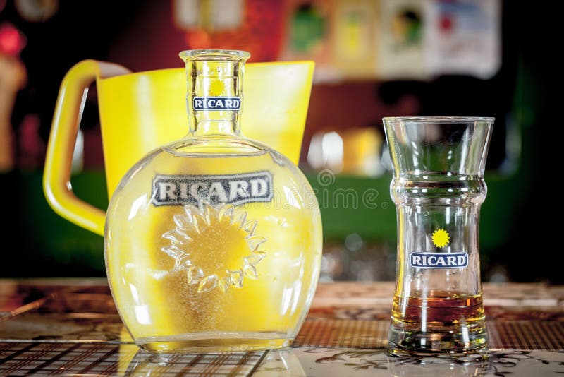Close up on a Ricard jug and a water bottle with its logo. Ricard is a pastis, an anise and licorice flavored aperitif royalty free stock images Close up on a Ricard jug and a water bottle with its logo. Ricard is a pastis, an anise and licorice flavored aperitif royalty free stock images