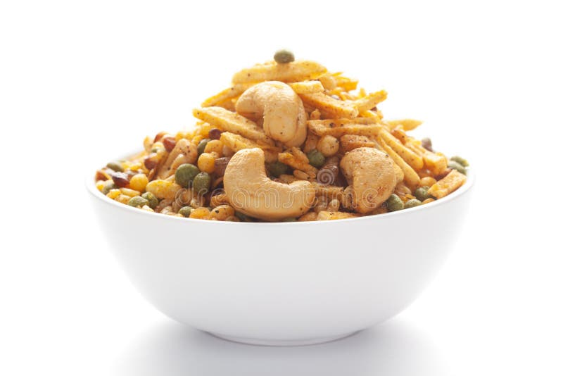 Close up of Rich Spicy Kaju Mixture  Indian namkeen snacks on a ceramic white bowl.