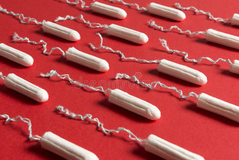 Close Up of Rows of Tampons on a Red Background