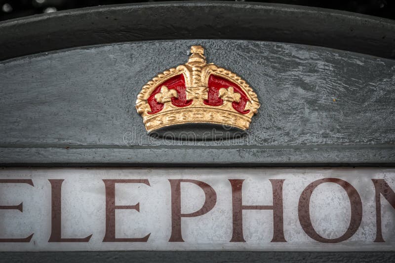 Close up of a royal crown symbol on an english grey phone booth in Bath UK