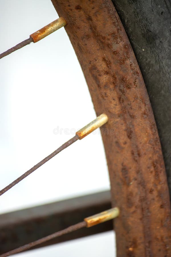 A rusty bicycle wheel with spokes - close-up stock photos